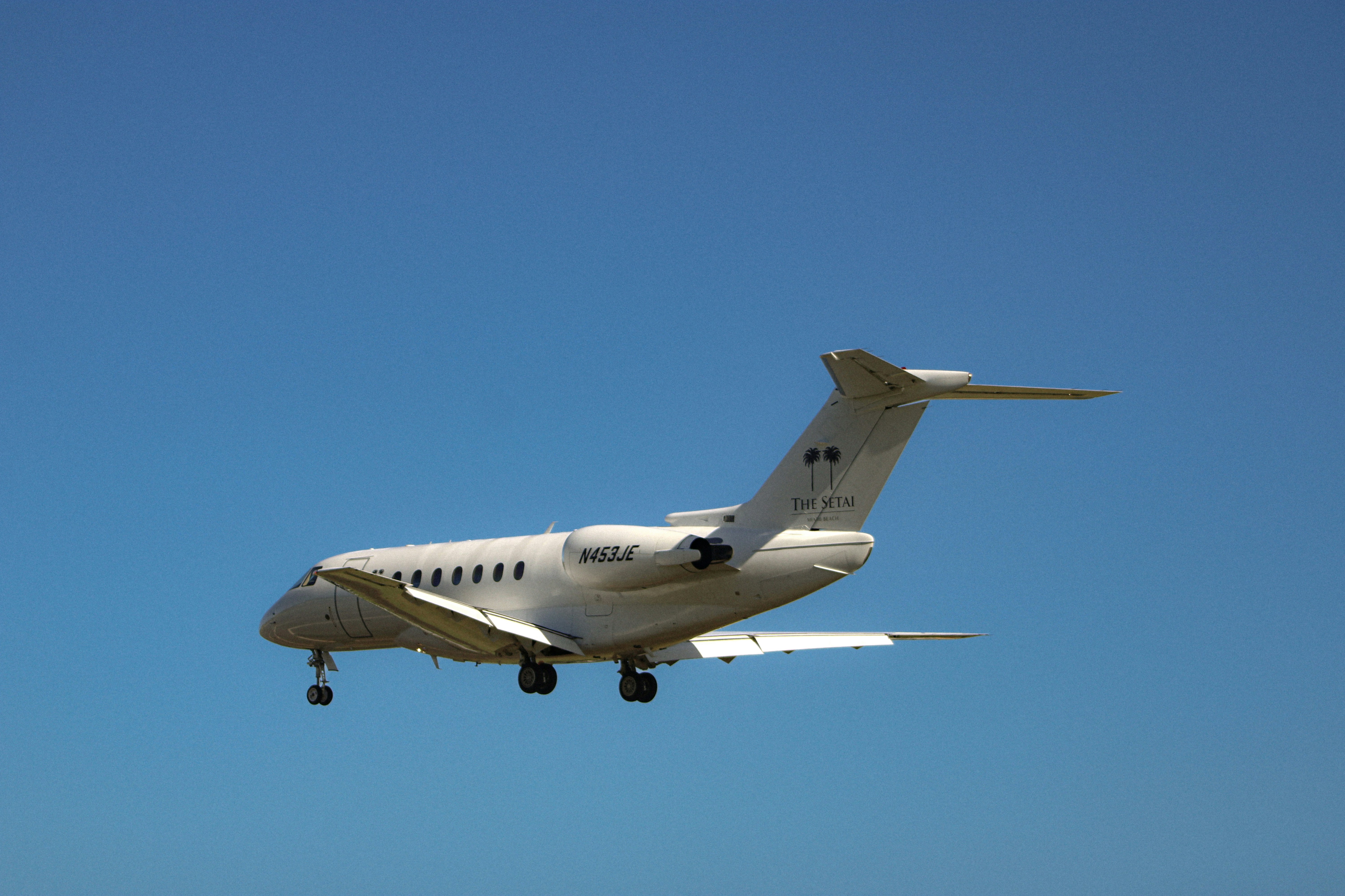 An airplane flying in the air with a clear blue sky in the background